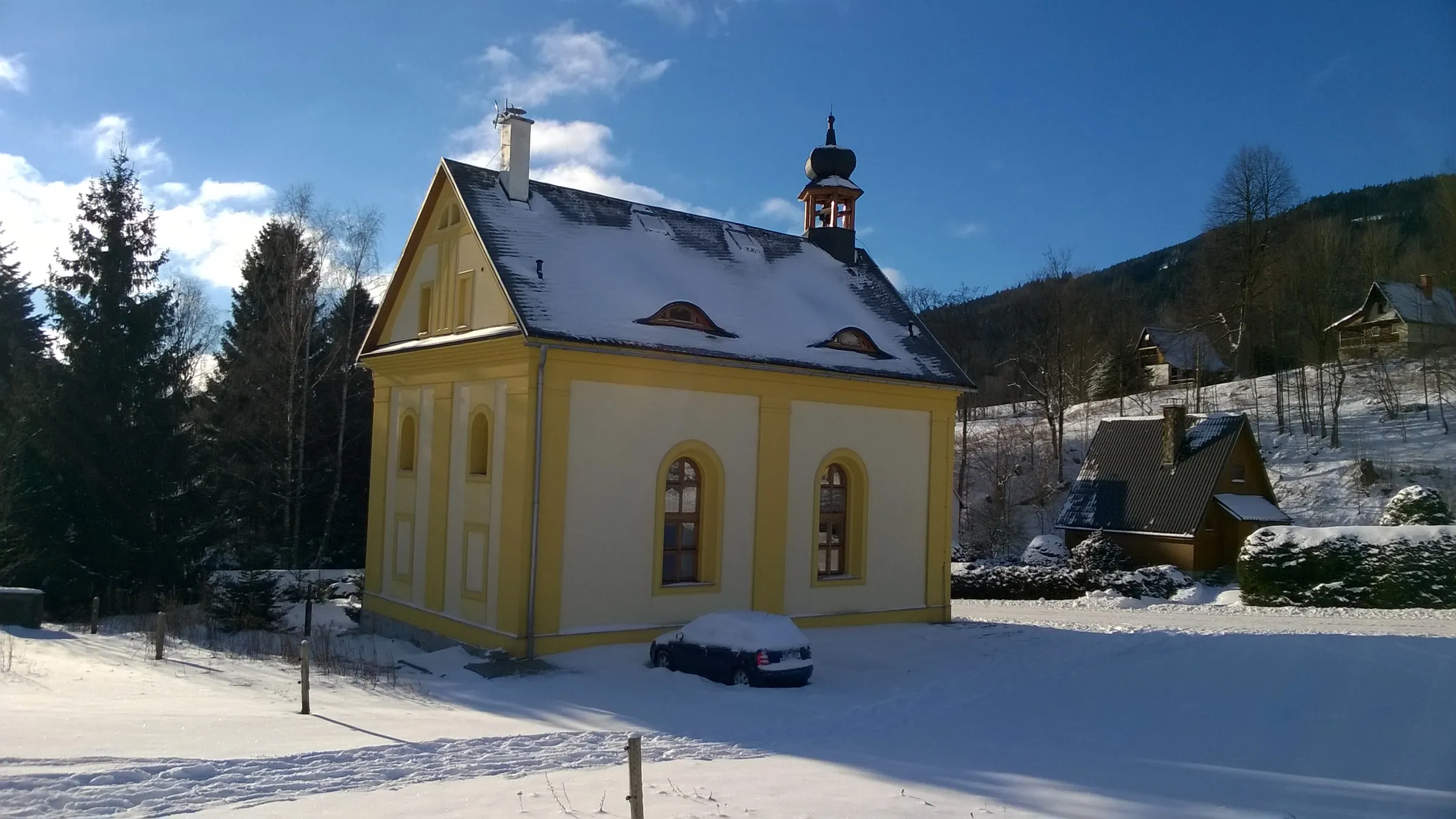 Penzion Pod Zvonem, a former chapel with a small bell tower, in winter