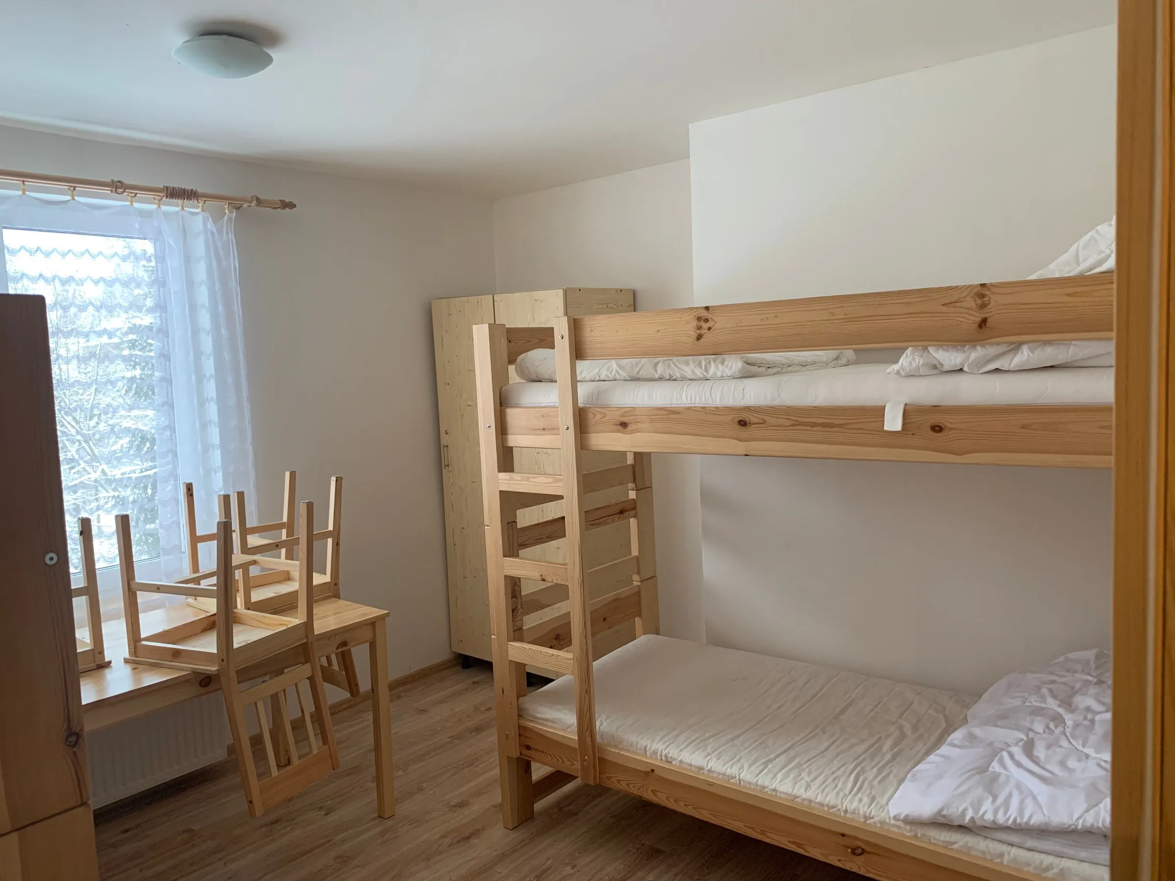 Room with bunk beds and a table
