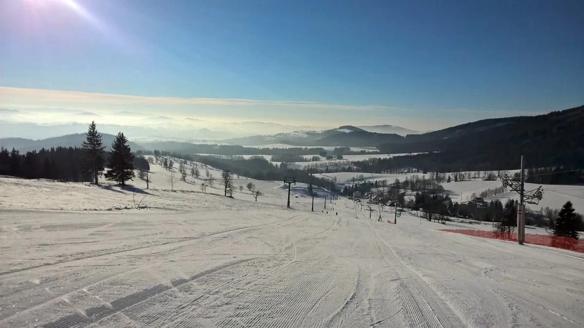 Groomed slope with a view of the mountains